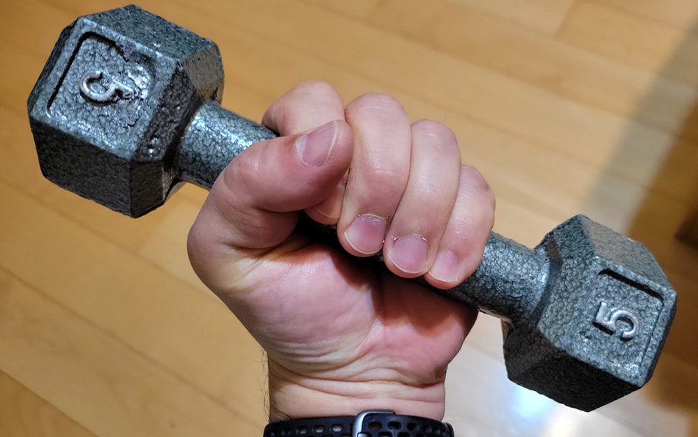 5 pound dumbbell being held by hand