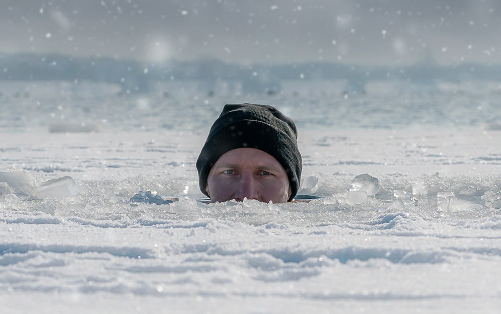A man in icy cold water