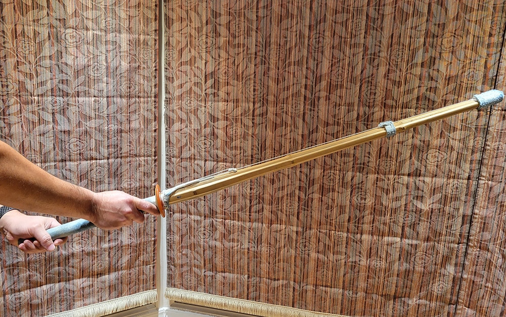 Hands holding a kendo shinai (bamboo sword)