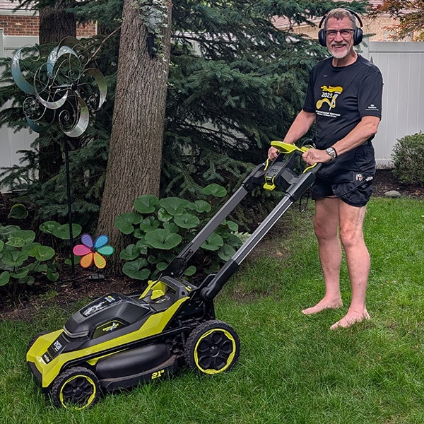 KAATSU user cutting grass while wearing KAATSU